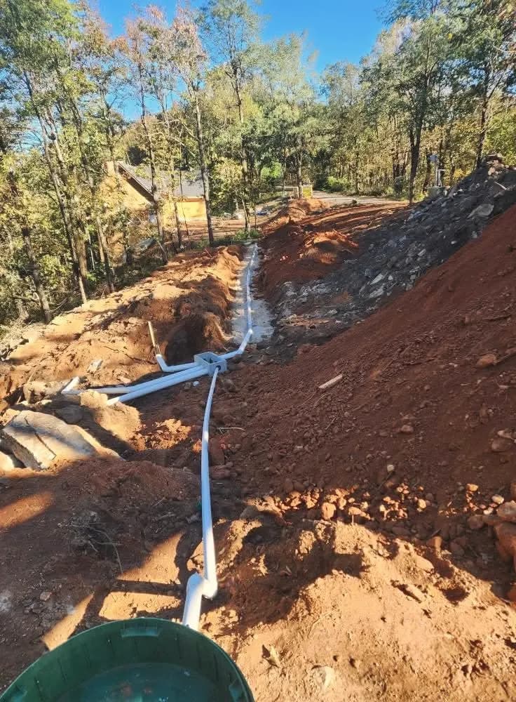 Septic line and riser on a hillside lot.